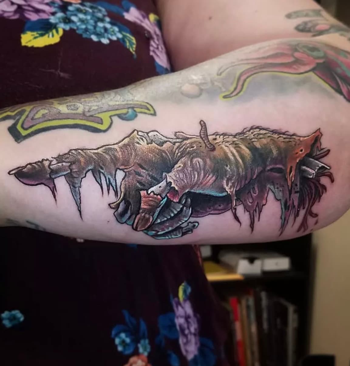 Detailed zombie fish tattoo with skeletal features on person's forearm